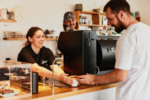 staff at audrey coffee giving hot coffee to customer